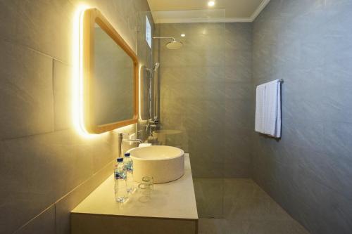 a bathroom with a white sink and a mirror at La Tano's Canggu in Canggu