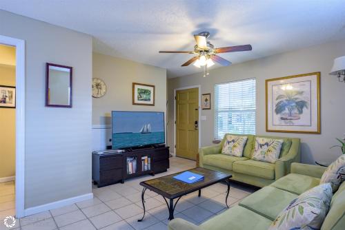 a living room with a couch and a flat screen tv at Bonaire Suite in Key West