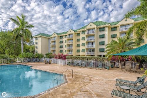 a resort with a swimming pool and a resort at Rum Cay Sunrise Suites in Key West