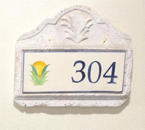 a sign on a wall with a number at Rum Cay Sunrise Suites in Key West