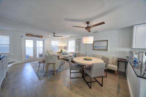 a kitchen and living room with a table and chairs at Villa Serena Duval Square in Key West