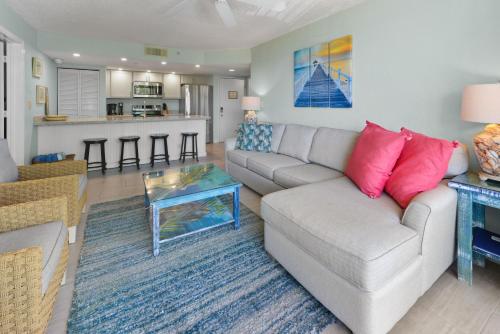 a living room with a couch and a table at Sunrise Suite 203 in Key West