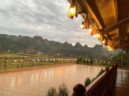 a building with a view of a river and mountains at Homestay Cánh Đồng Vàng in Hữu Lũng