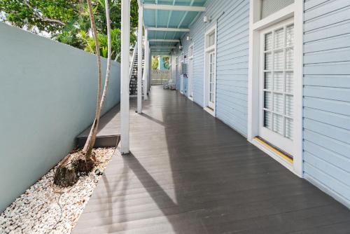a porch with a hammock on the side of a house at La Casa De Luces in Key West