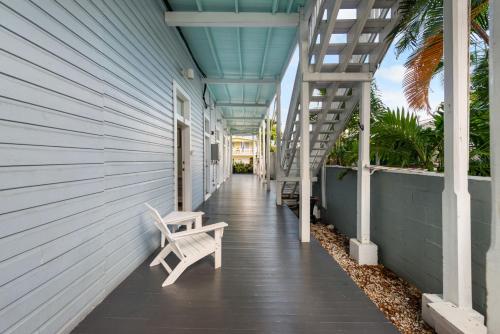a porch with a bench on the side of a building at La Casa De Luces in Key West