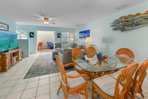 a living room with a glass table and chairs at Casabella Duval Square in Key West