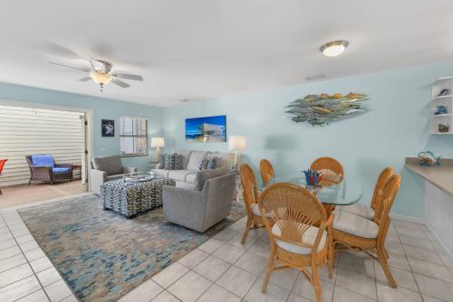 a living room with a couch and a table and chairs at Casabella Duval Square in Key West