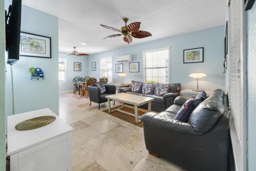 a living room with a couch and a table at Orchid Suite in Key West