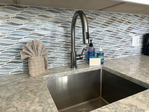 a kitchen sink with a faucet on a counter at La Casa De Luna in Key West
