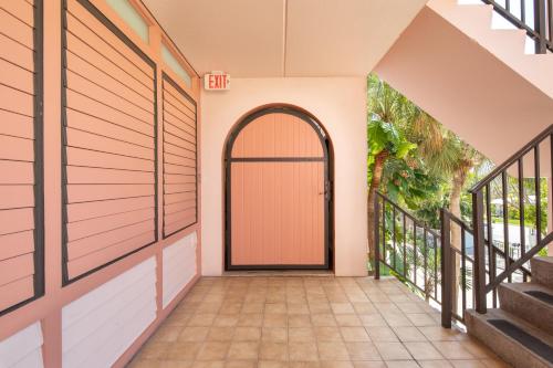 an arched door in a house with a hallway at Beach Club Shangra La 206 in Key West