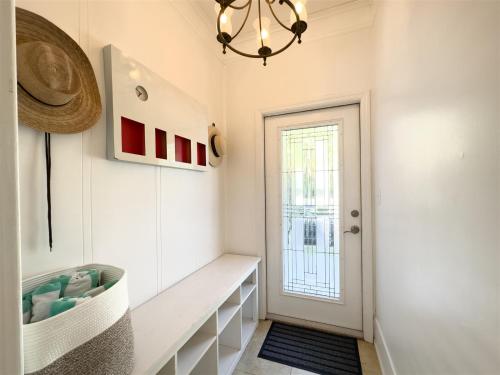 a bathroom with a sink and a window and a chandelier at Olivias Landing in Key West