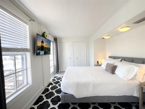 a bedroom with a white bed and a window at Olivias Landing in Key West