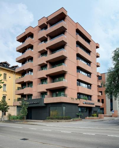 a tall building on the side of a street at VISIONAPARTMENTS Lugano - contactless check-in in Lugano