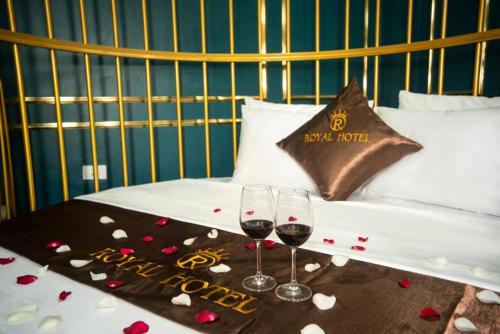 two glasses of red wine on a table with hearts at Royal Hotel Bắc Ninh in Bắc Ninh