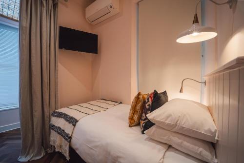 a bedroom with a bed with pillows on it at Twenty Nevern Square Hotel in London