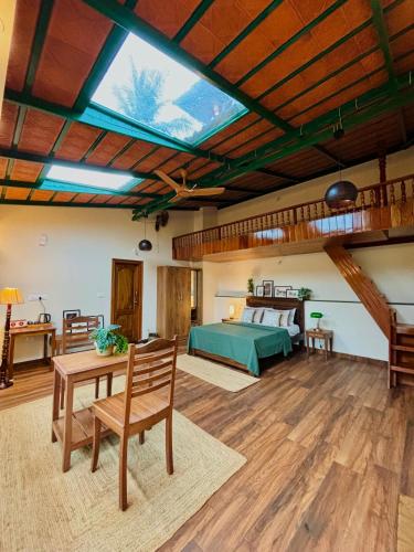 a bedroom with a bed and a wooden ceiling at The Home Resort - Coorg in Kakkabe