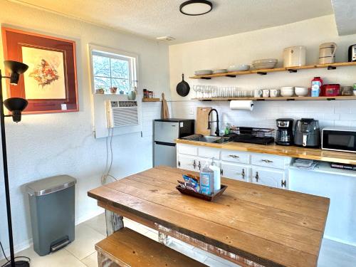 a kitchen with a wooden table in a room at 2br Townhouse Taft Stadium & Plaza Dining #n39 in Oklahoma City