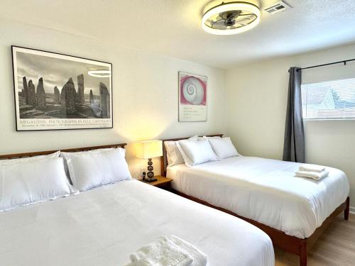 a hotel room with two beds and a window at 2br Townhouse Taft Stadium & Plaza Dining #n39 in Oklahoma City