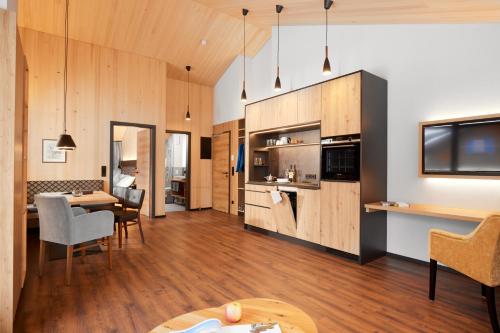 a living room with a kitchen and a dining room at Siplinger Suites - Ferienwohnungen - Sauna und Fitness in Balderschwang