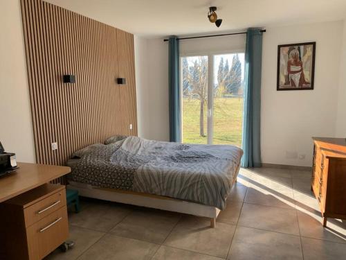 une chambre avec un lit et une grande fenêtre dans l'établissement Villa provençale en campagne, à Maillane