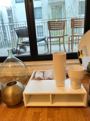 a shelf with vases and other items on a table at visit Brussels city in Brussels