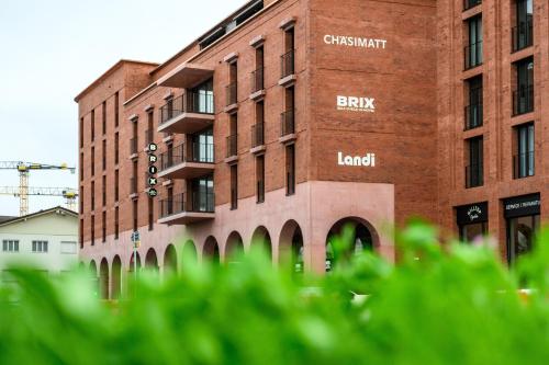 a brick building with the wordsheast brick lender on it at BRIX - Self Check-In Hotel in Rotkreuz