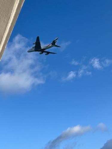 a plane is flying in the sky at Bluebay 360 seaview in Blue Bay