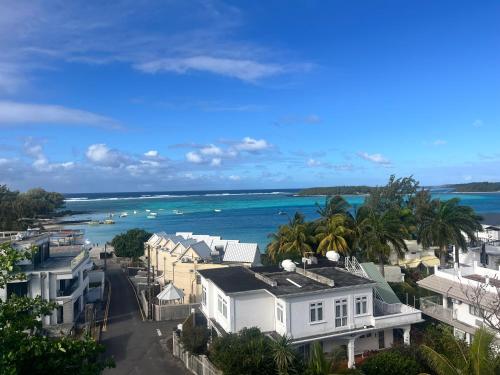 a view of the ocean with houses and a street at Bluebay 360 seaview in Blue Bay