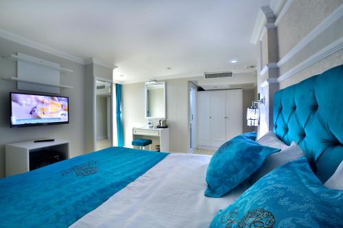 a bedroom with a large bed with blue pillows at Glamour Hotel Istanbul Sirkeci in Istanbul