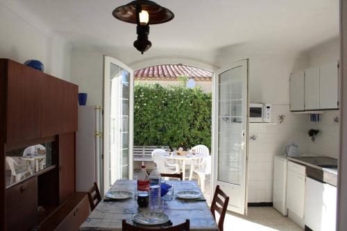 une cuisine avec une table et une salle à manger avec une table et des chaises dans l'établissement Maison 3 pièces PORT LA NOUVELLE PN000-156, à Port-la-Nouvelle