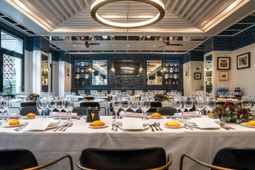 a dining room with a long table with wine glasses at Radisson Blu 1882 Hotel, Barcelona Sagrada Familia in Barcelona
