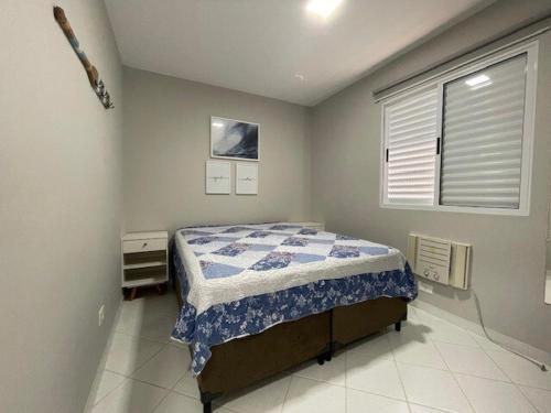 a bedroom with a bed and a window in it at Beautiful Casa em Riviera in Bertioga