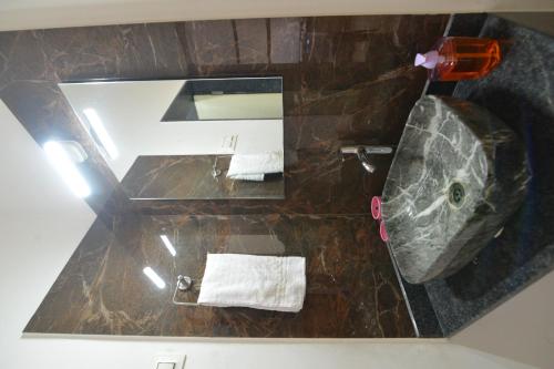 an overhead view of a bathroom with a sink and a toilet at Guruprasad Home Stay in Kolhapur
