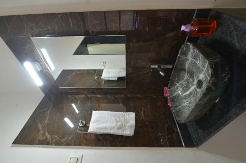 an overhead view of a bathroom with a sink and a toilet at Guruprasad Home Stay in Kolhapur