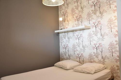 une chambre avec un lit avec un papier peint fleuri dans l'établissement Appartement 2 pièces - Gruissan GN460-010, à Gruissan