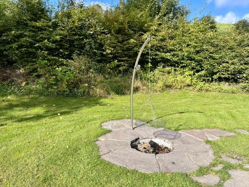 a metal pole in the middle of a grass field at Biobetrieb Lippenhof in Breitnau