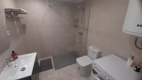 a bathroom with a shower and a sink and a toilet at Penthouse studio with sea views in La Cala de Mijas