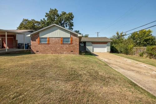 a brick house with a yard in front of it at EXPO HOME just minutes from downtown Tulsa in Tulsa