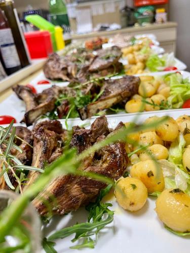 two plates of food with meat and vegetables on a table at Alpenpension Gasthof in Ratten
