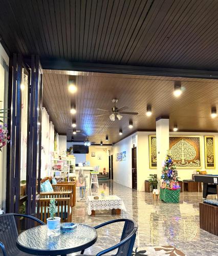 a restaurant with tables and chairs and a ceiling at Thai Classic House in Patong Beach
