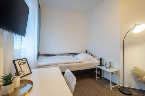 a bedroom with a bed and a desk and a table at Hotel Garni Orlova in Orlová