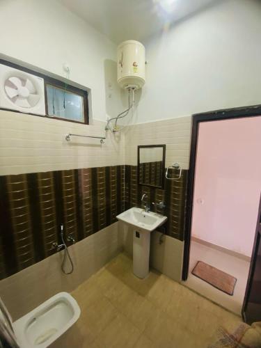 a bathroom with a sink and a toilet at Monal Inn in Mīlam