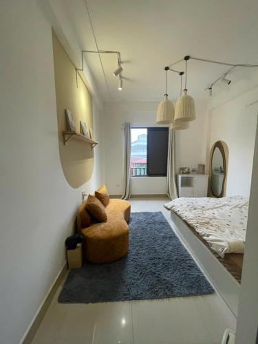 a bedroom with a bed and a chair and a rug at Luxe Paradise 21 Nguyen Van Troi in Hanoi