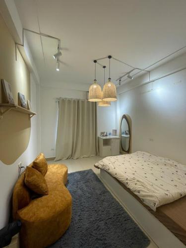 a bedroom with a bed and a chair and a mirror at Luxe Paradise 21 Nguyen Van Troi in Hanoi