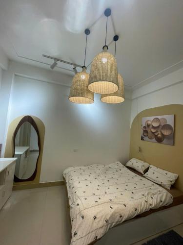 a bedroom with two lamps and a bed in it at Luxe Paradise 21 Nguyen Van Troi in Hanoi