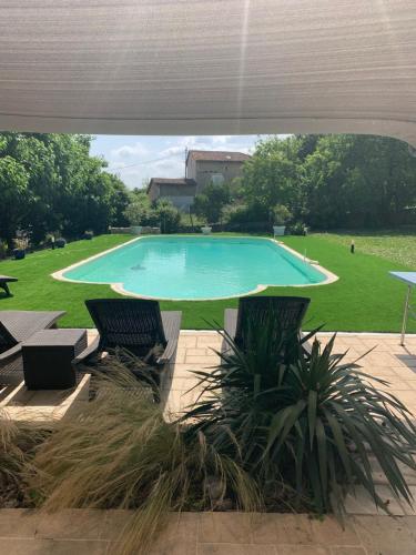 - une grande piscine avec 2 chaises dans la cour dans l'établissement Le Clos Lagrange-10 pers-Piscine privée, à Varaignes