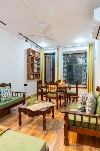 a living room with wooden floors and wooden tables at Alaya Stays Ramalaya - Room with balcony in Jaipur