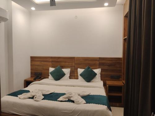a bedroom with a bed with towels on it at Hotel Vaidik Ganga in Rishīkesh
