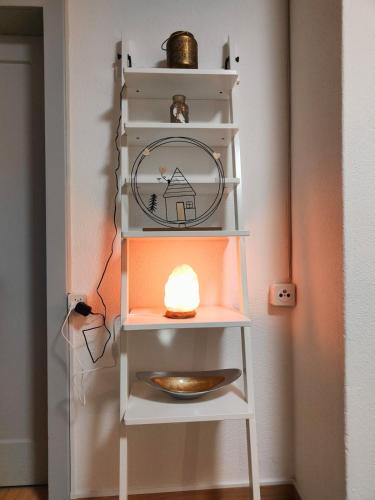 a shelf with a candle in a room at Heimelige 4 Zimmerwohnung im schönen Val Poschiavo in Prada