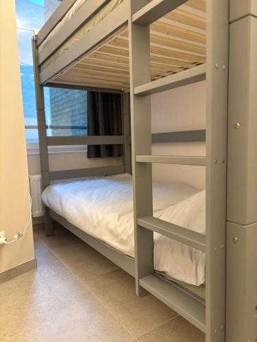 a bunk bed room with two bunk beds in it at Ruytingen Modern Seaside Suite in Koksijde